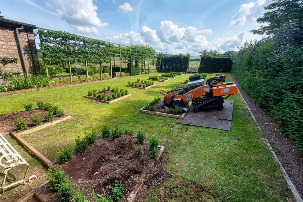 Stump grinding equipment on lawn in Carlisle.